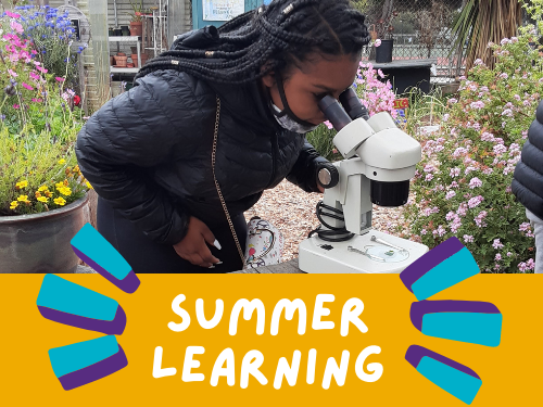 student looking through a microscope