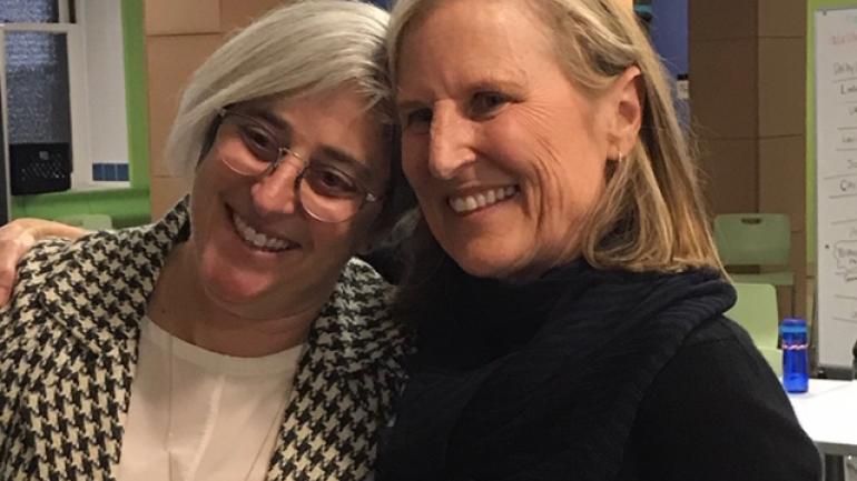 Suzanne Schutte and Executive Director Olken smile together at an event