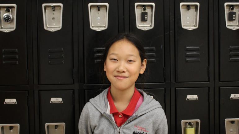 Aram poses in front of lockers