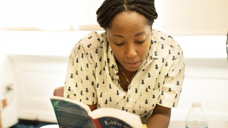 A Gateway staff member reading a novel