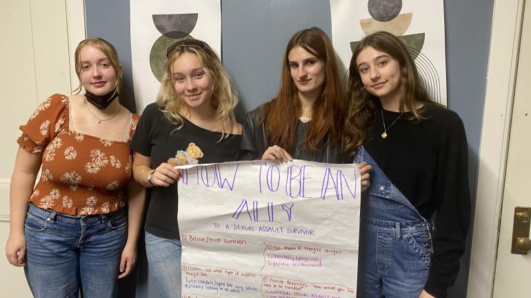 SASHA members pose with poster