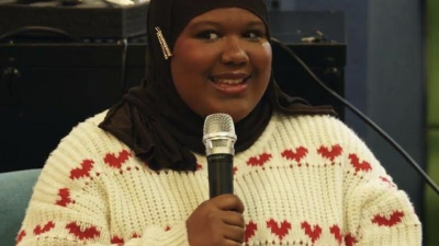 A student speaks into a mic