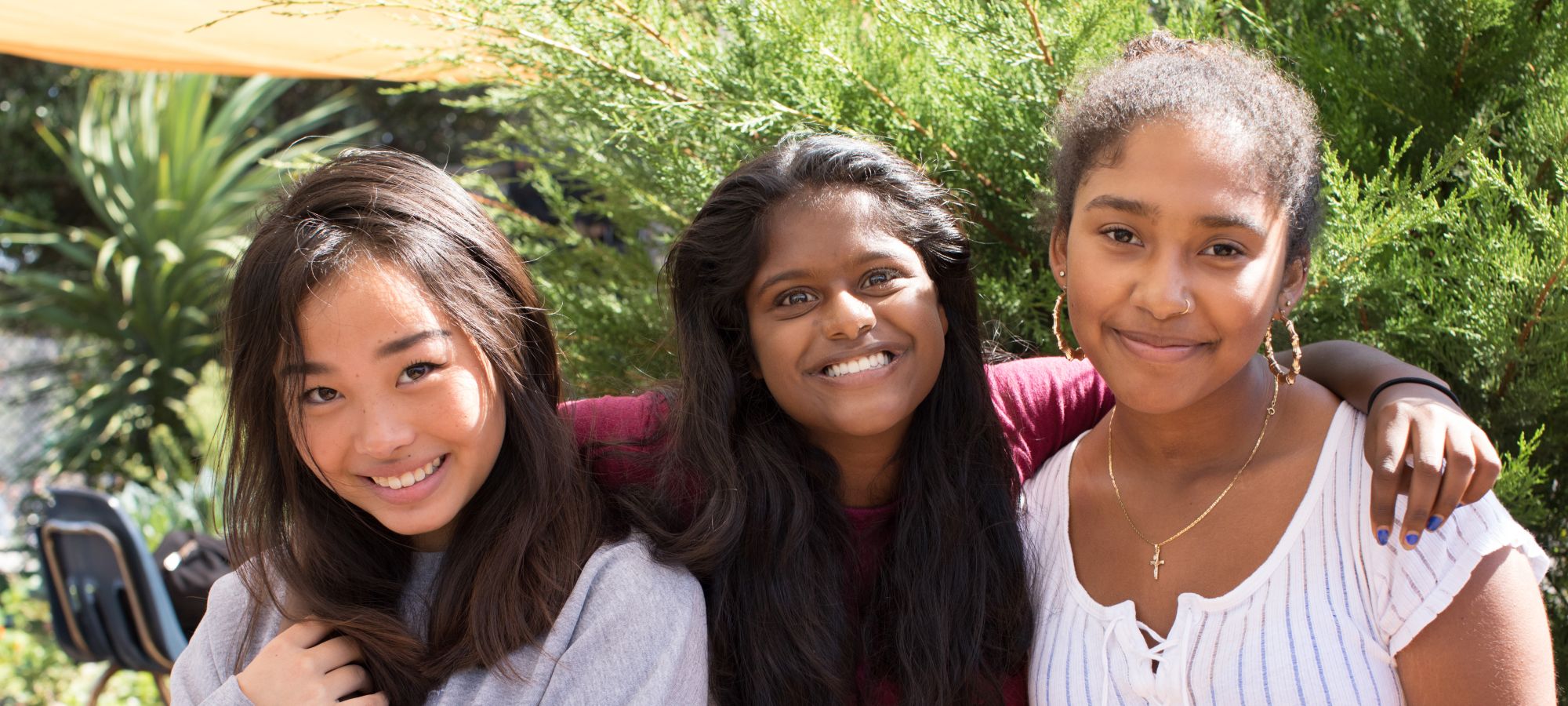 female students pose together in the garden