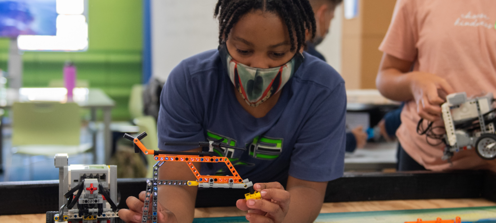 student building a lego robot