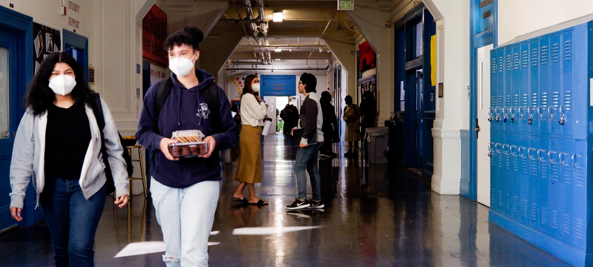 Students chat in a hallway