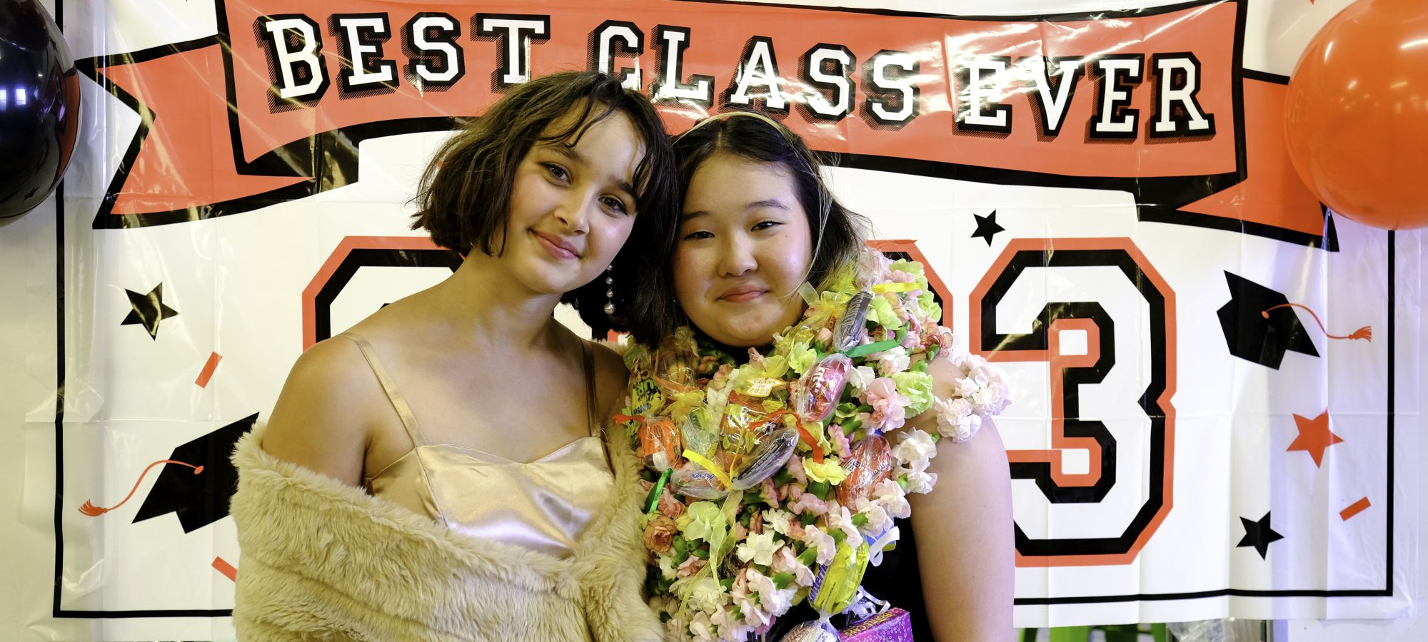 Two students posing at a graduation celebration