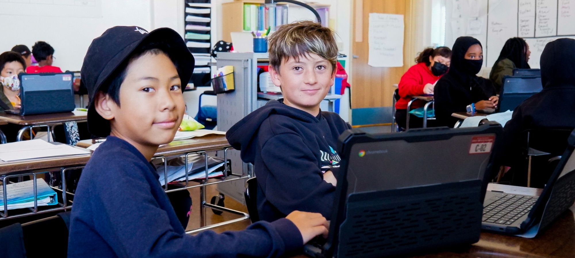 Two boys studying with a laptop