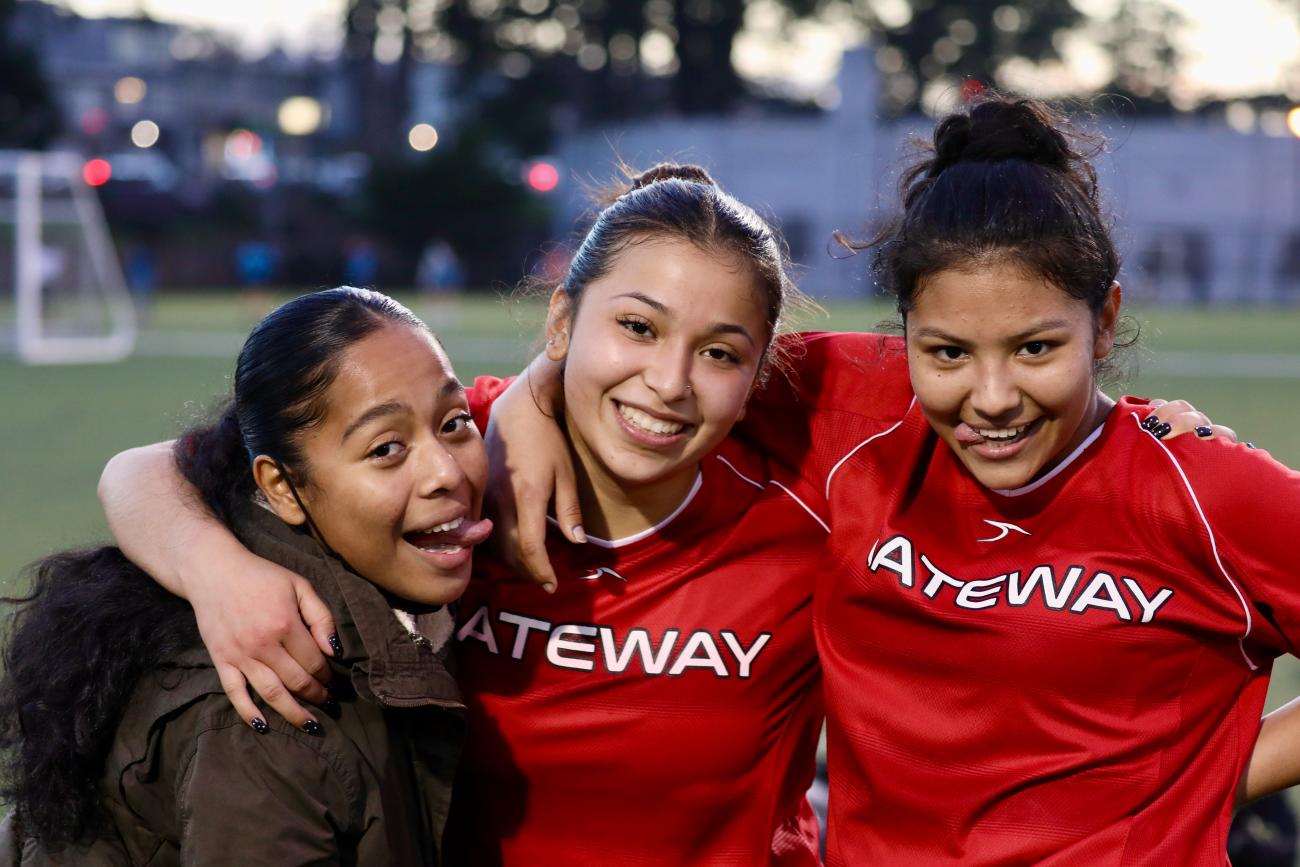 Women's soccer players pose